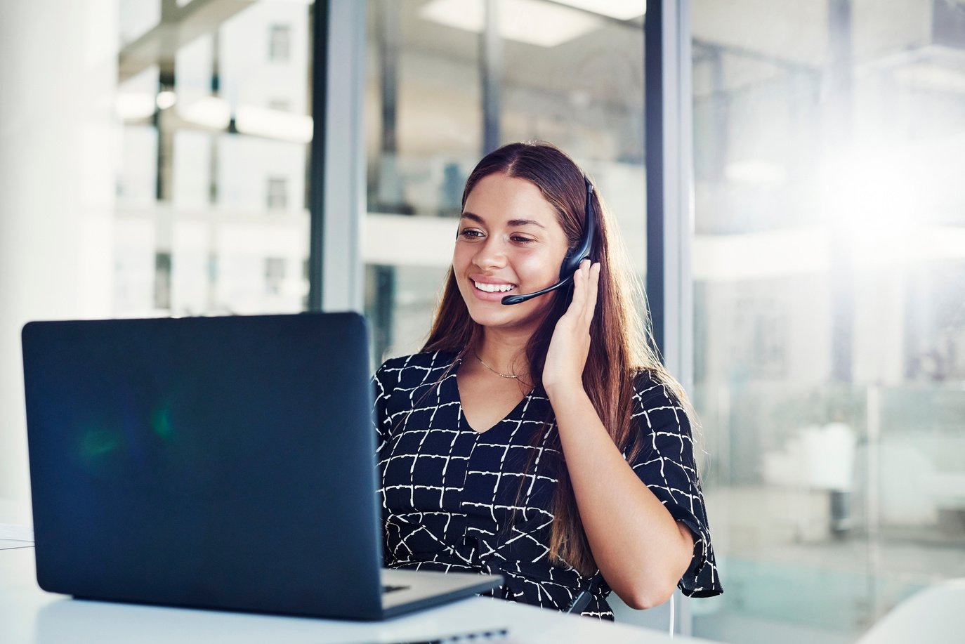 Female Telemarketer Working on a Laptop in the Office