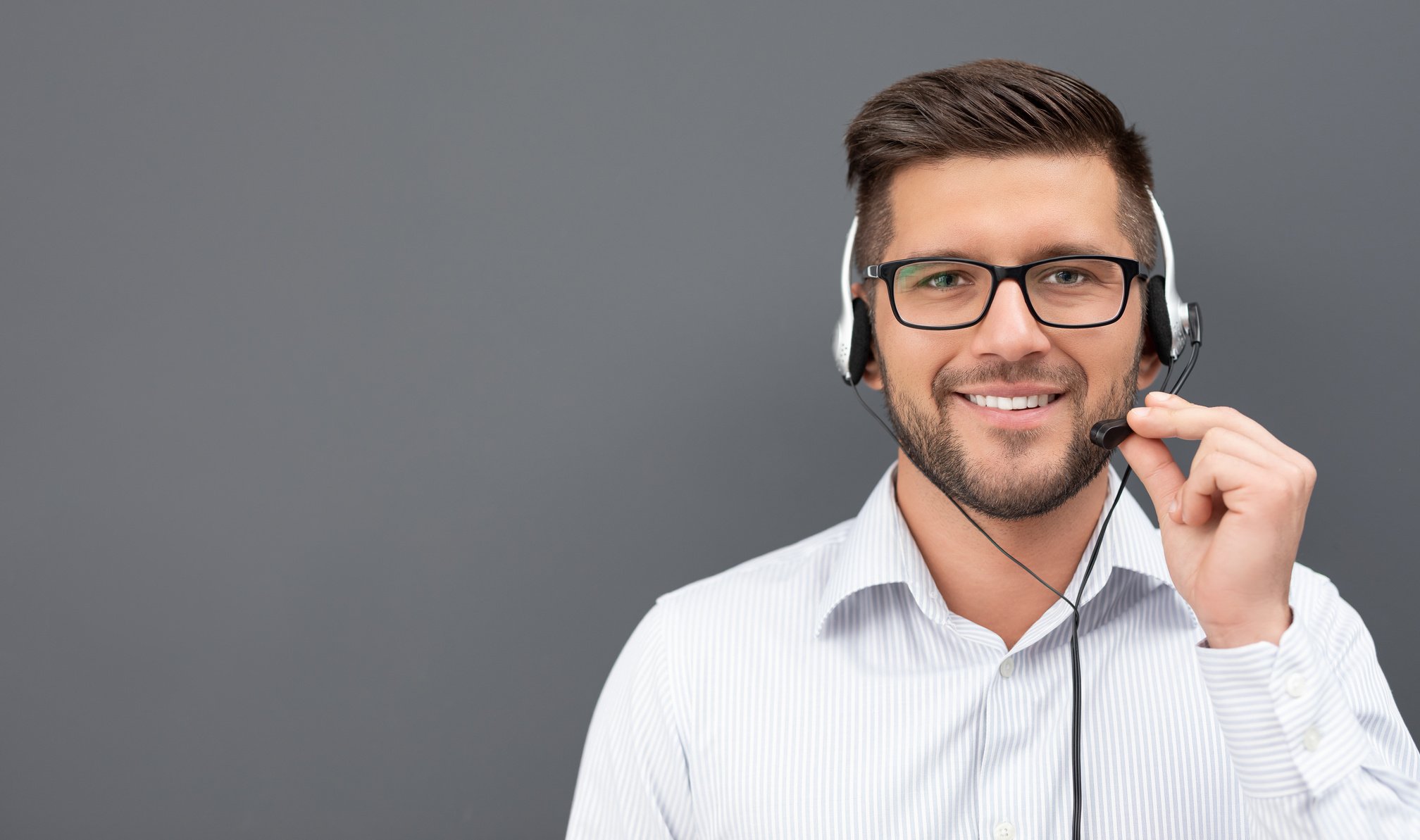 Call Center Employee with Headset on Gray Background